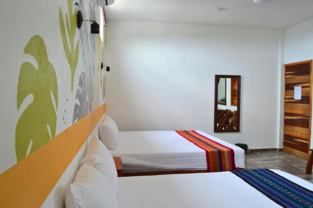 Postel nebo postele na pokoji v ubytování Hotel Axolotl
