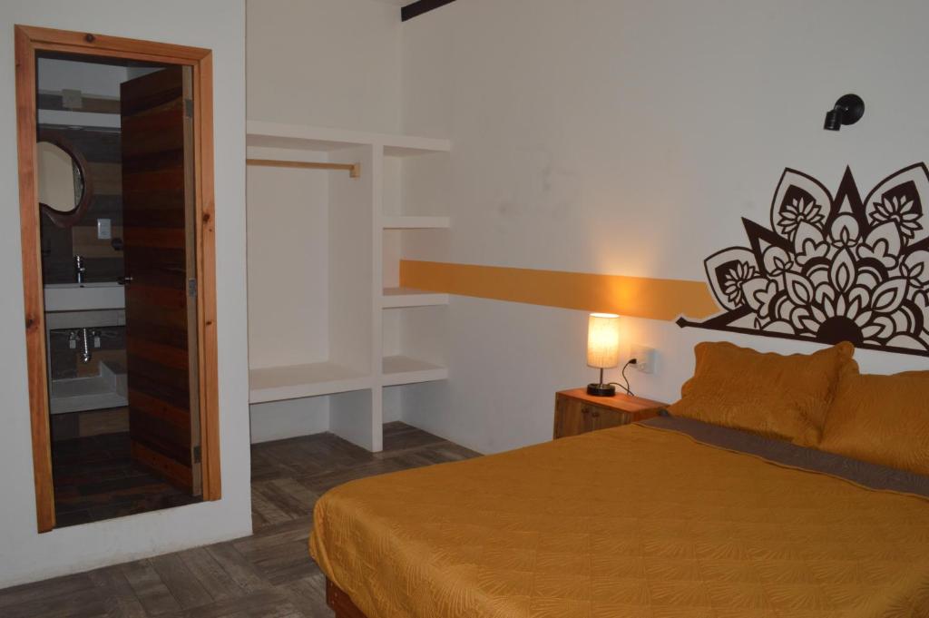 Postel nebo postele na pokoji v ubytování Hotel Axolotl