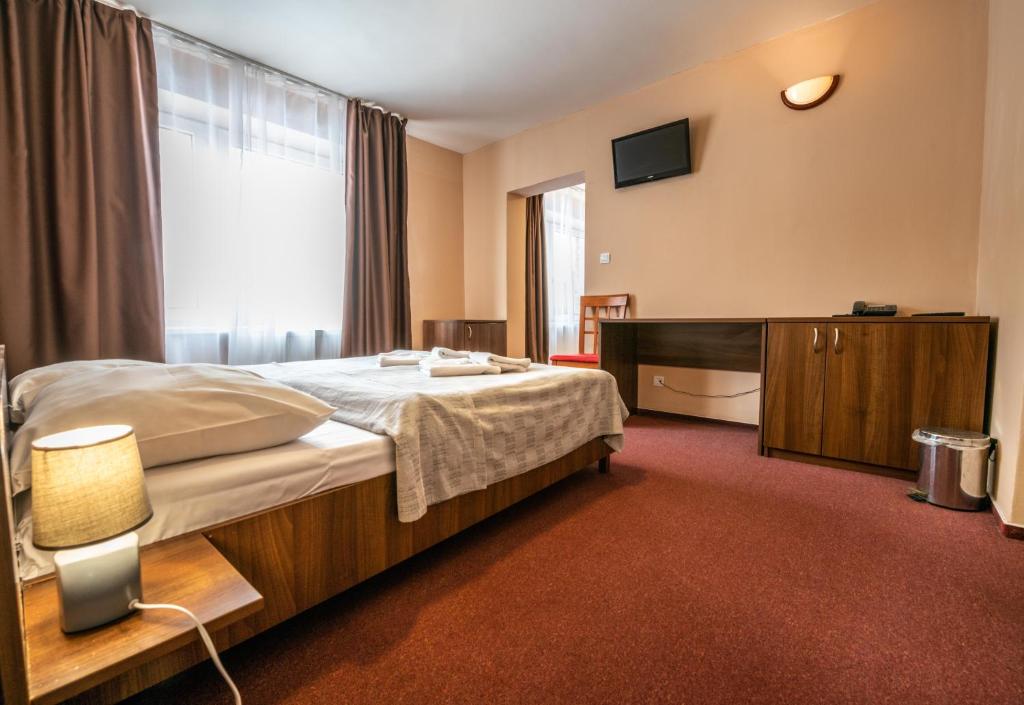 Postel nebo postele na pokoji v ubytování Grand Hotel rooms