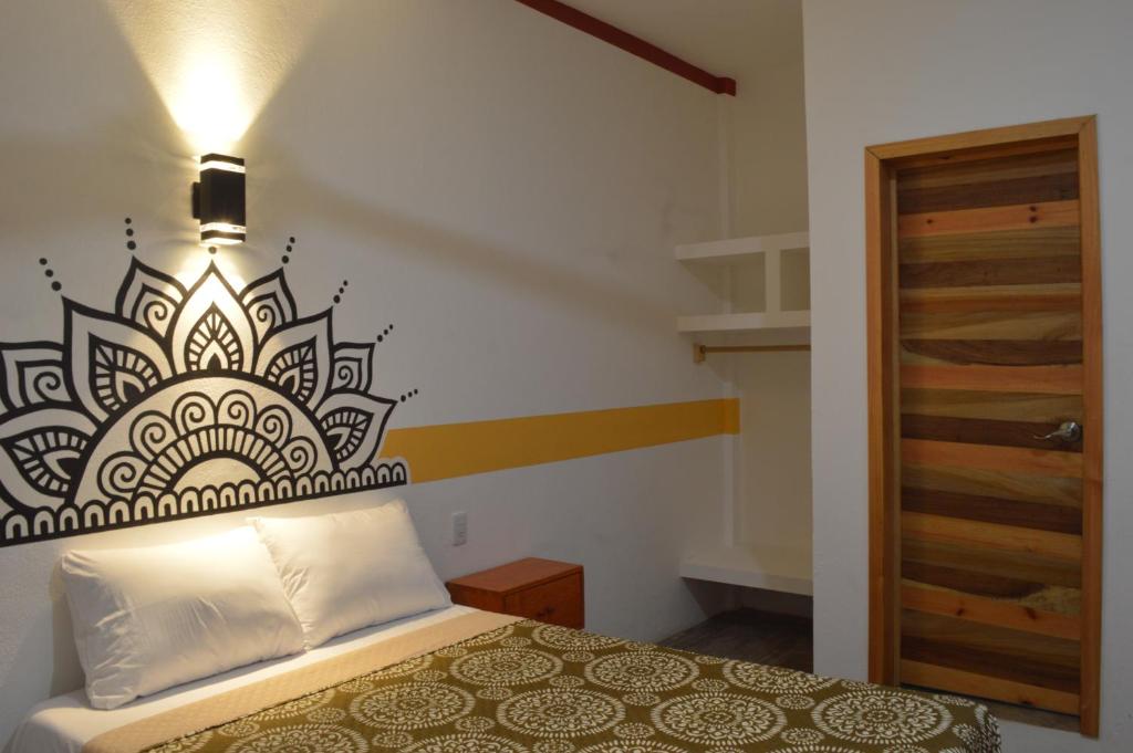 Postel nebo postele na pokoji v ubytování Hotel Axolotl