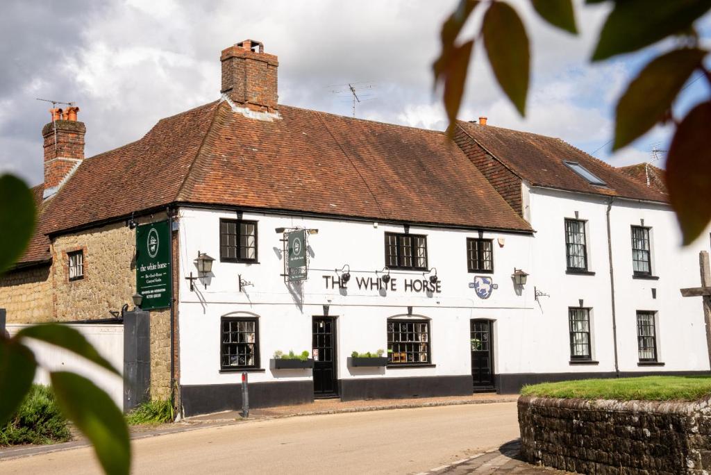 a white building with writing on the side of it at The White Horse, Rogate in Petersfield