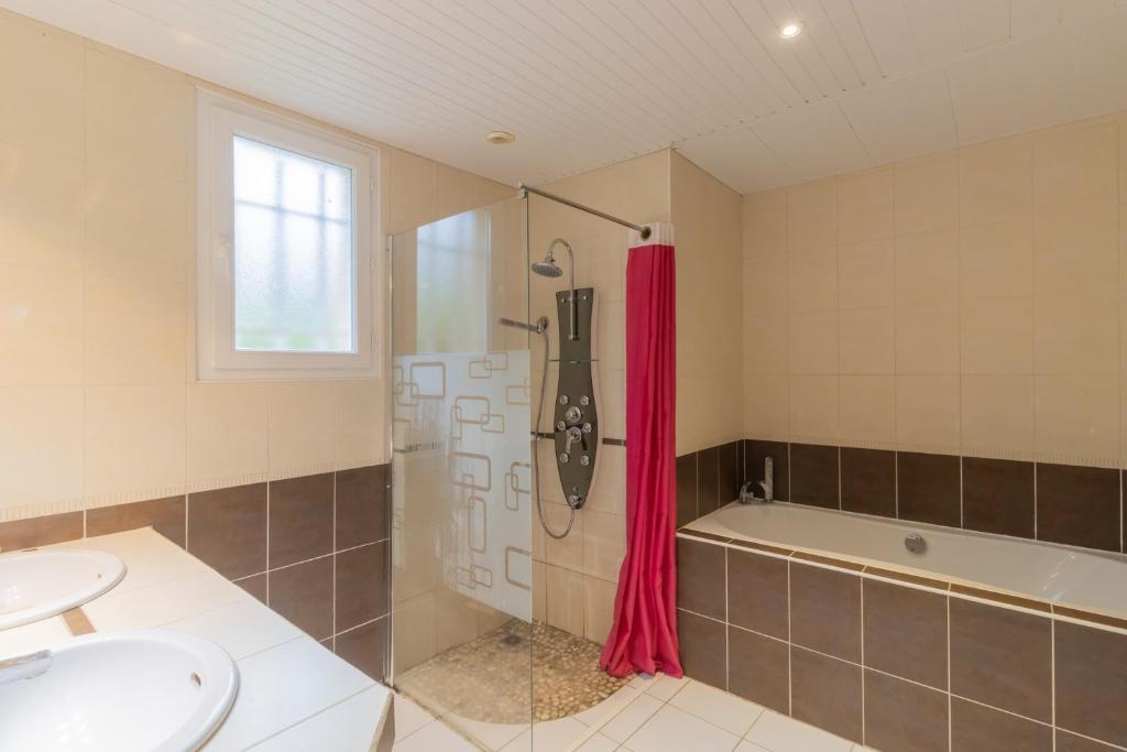 a bathroom with a shower and a sink and a tub at Maison Sébastien in Saint-Pierre-de-Côle