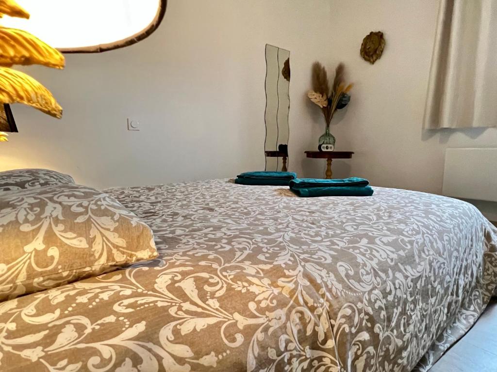 una cama con almohadas azules en una habitación en Appartement Livingstone -2 pers., en Charleville-Mézières