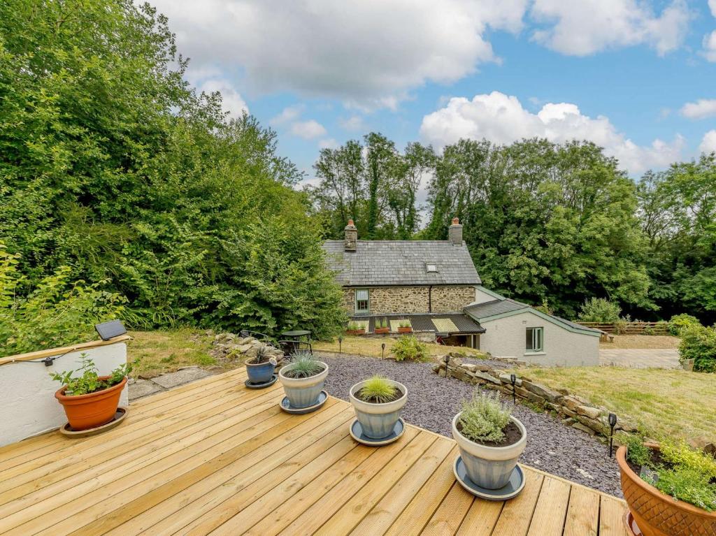 a deck with potted plants on top of a house at 2 bed property in Llandysul 88775 in Llanfihangel-ar-Arth