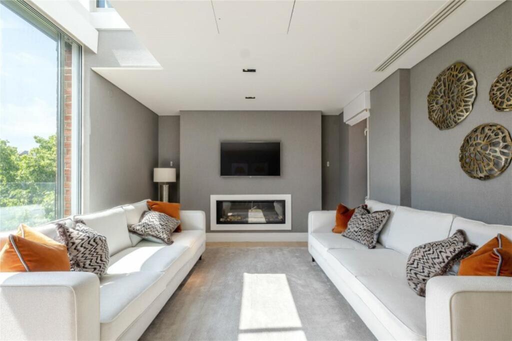 a living room with two white couches and a fireplace at Lux, Large Central Mayfair Location Flat in London