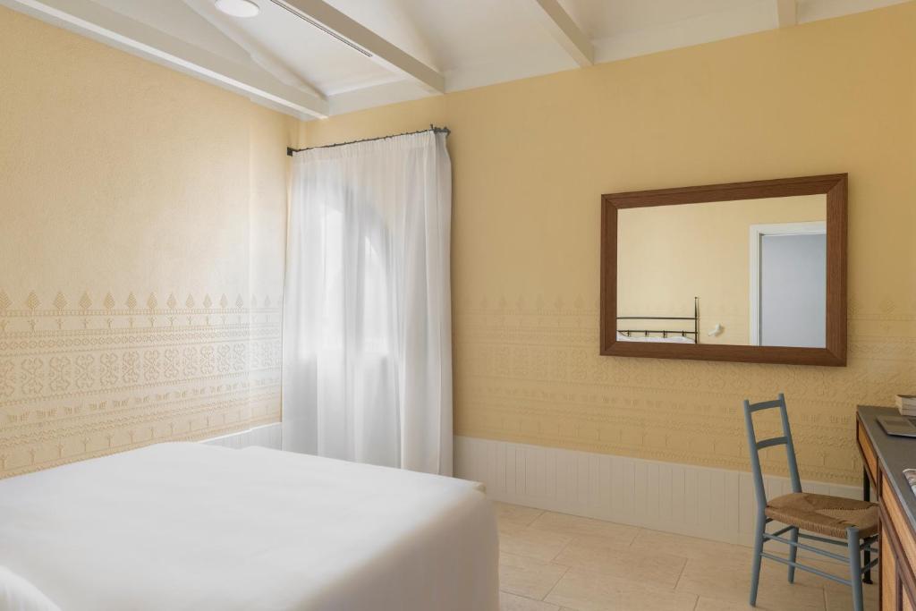 Cama ou camas em um quarto em Hotel Le Dune Piscinas