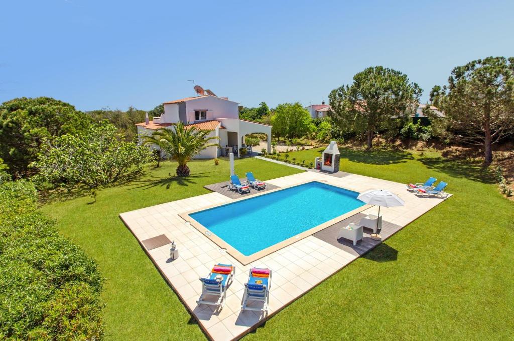 an aerial view of a house with a swimming pool at Villa Figueiras by Villa Plus in Lagoa