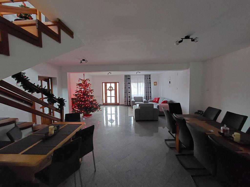 a living room with a christmas tree in the middle at Casa Sandu-Sadova in Sadova