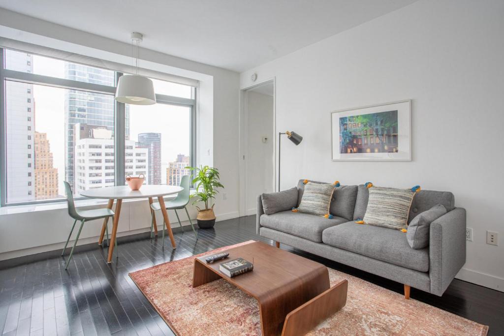 a living room with a couch and a table at Financial District 1br w WD gym elevator NYC-1370 in New York