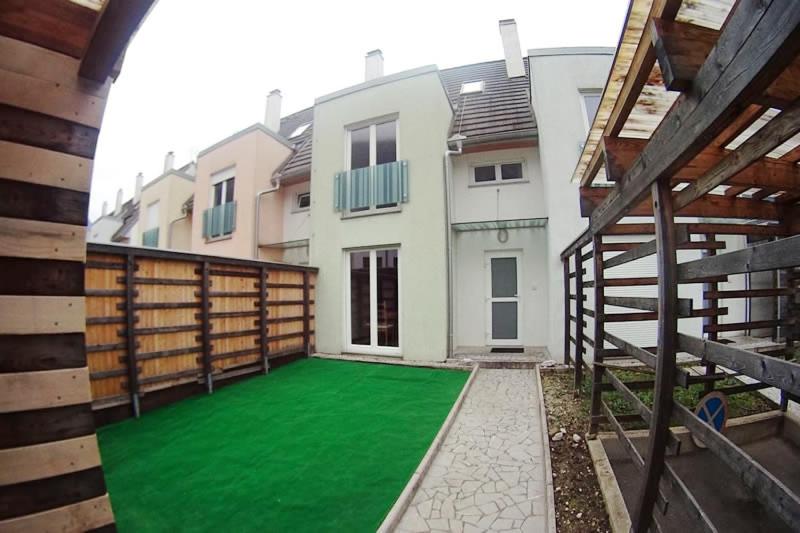 a house with a green lawn in front of it at Bovec Garni Apartment 7 in Bovec