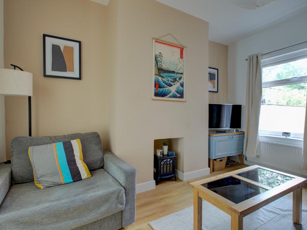 a living room with a couch and a coffee table at Pass the Keys Colourful property sleeps 6 in Manchester