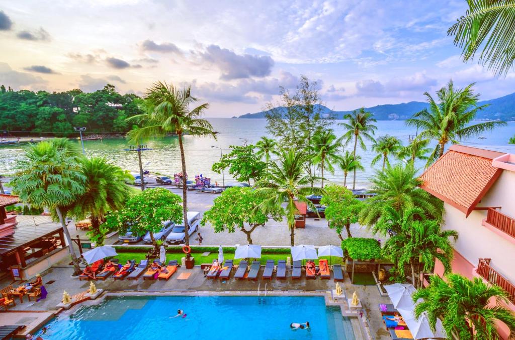 a view of the pool at a resort with palm trees at 普吉岛-瓶庐海景度假酒店 Phuket PL Seaview Resort in Patong Beach