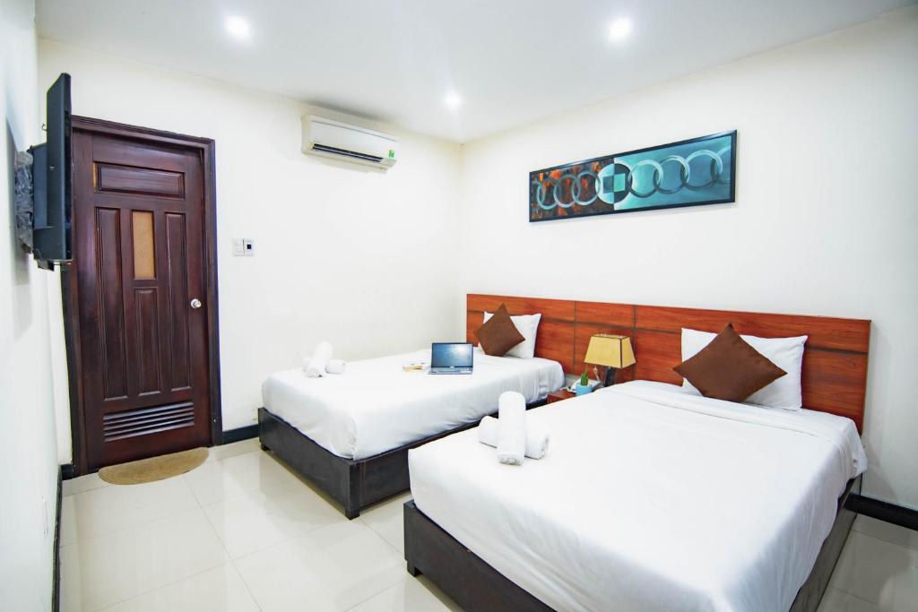 Postel nebo postele na pokoji v ubytování Quoc Cuong Center Da Nang Hotel by Haviland