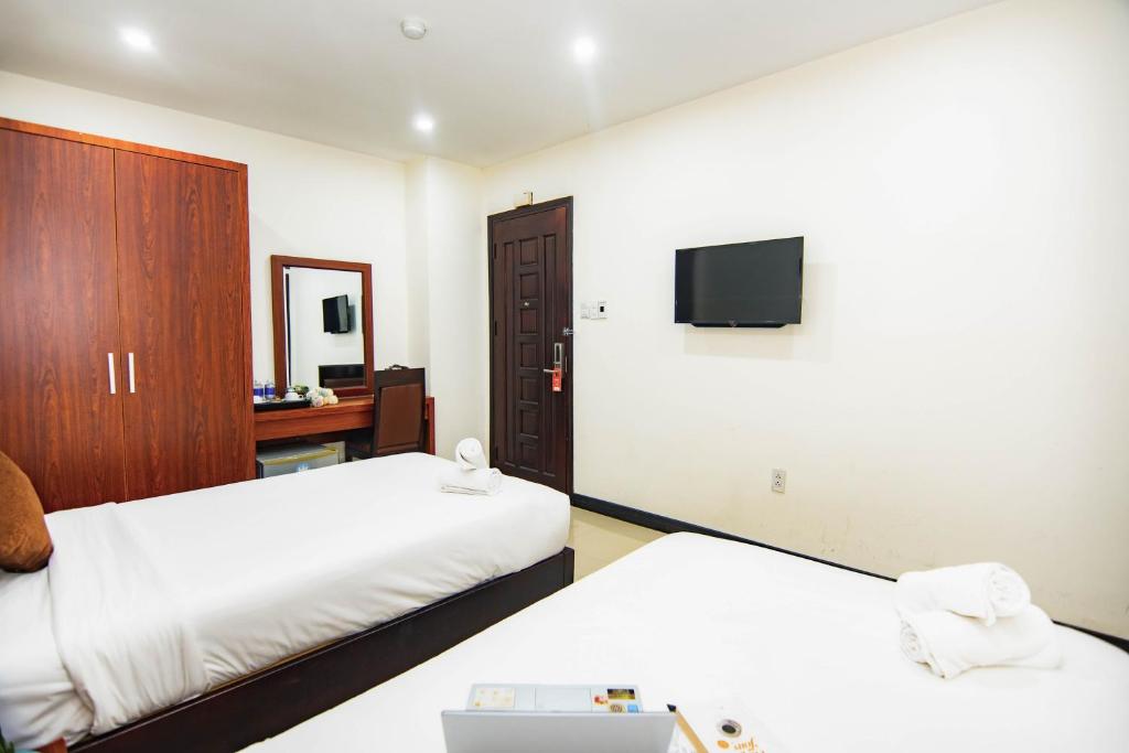 Postel nebo postele na pokoji v ubytování Quoc Cuong Center Da Nang Hotel by Haviland