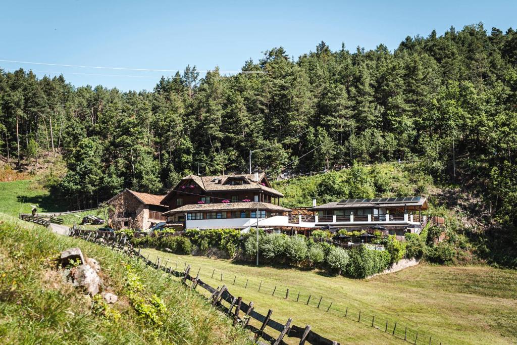 a house on the side of a hill at Exclusive Chalet Grumer 700 sqm in Soprabolzano