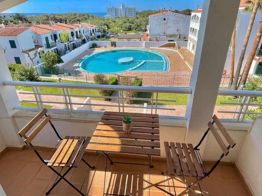 a balcony with two chairs and a swimming pool at Mitjaneta - Apartamento con piscina in Cala en Blanes