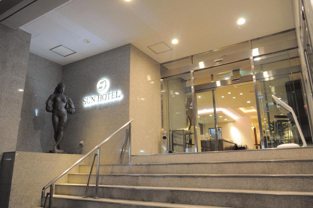 a statue of a man on the wall of a building at Asahikawa Sun Hotel in Asahikawa