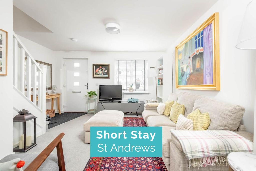 a living room with a couch and a tv at Fort Avenue - No 31 Guardbridge in Guardbridge