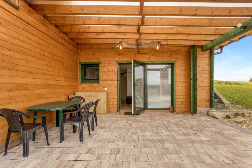 une terrasse avec une table et des chaises. dans l'établissement Nature Cottage in Gabrce with sauna, à Rogaška Slatina