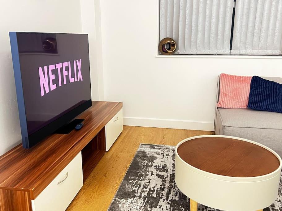 a living room with a tv and a couch at Relax in this cosy Haven near Glenfield and Royal Infirmary Hospitals in Leicester