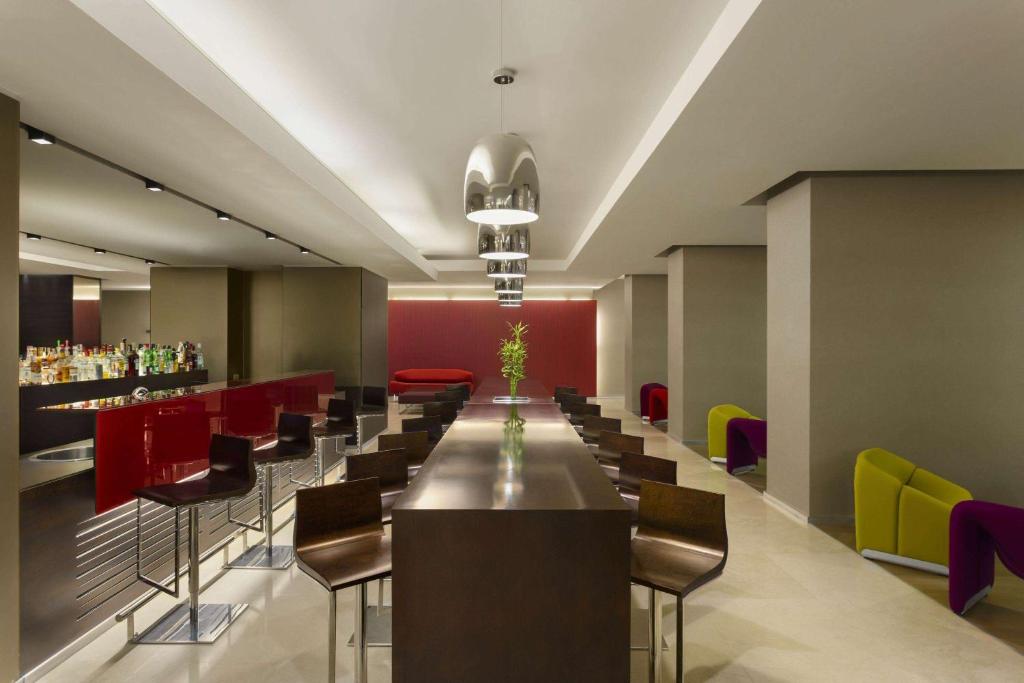a long dining room with a long table and chairs at Ramada Plaza by Wyndham Bucharest Convention Center in Bucharest