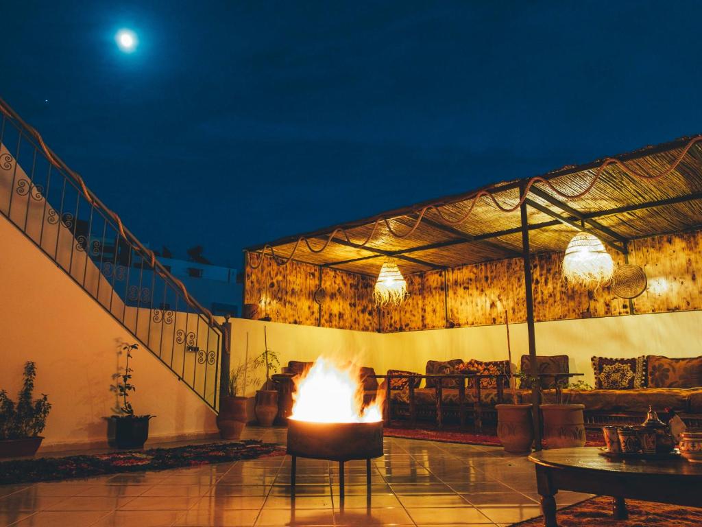 een vuurplaats in een patio 's nachts bij CHILL SURFER HOSTEL in Tamraght Ouzdar