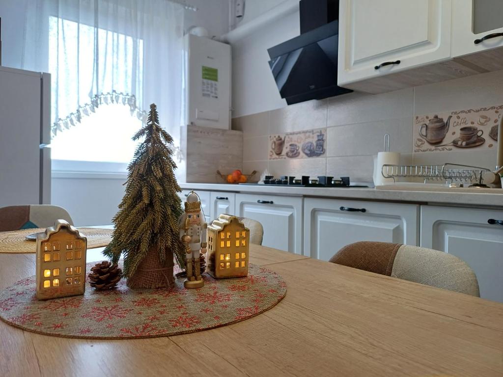 a kitchen with a table with a christmas tree on it at Apartament Ramonte in Zărneşti