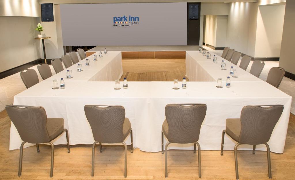 a large white table in a room with chairs at Park Inn by Radisson Bournemouth in Bournemouth