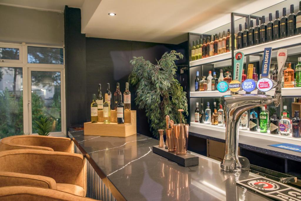 a bar with a lot of bottles of alcohol at Park Inn by Radisson Bournemouth in Bournemouth