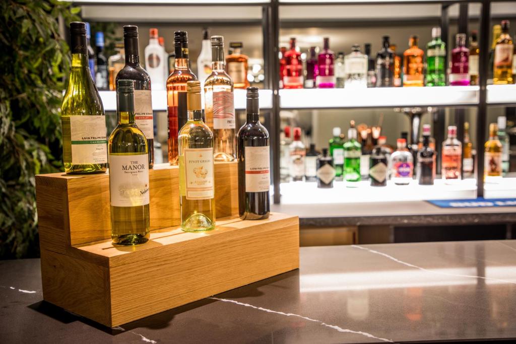 a bunch of bottles of wine sitting on a counter at Park Inn by Radisson Bournemouth in Bournemouth