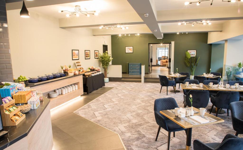 a restaurant with tables and chairs and a buffet at Park Inn by Radisson Bournemouth in Bournemouth