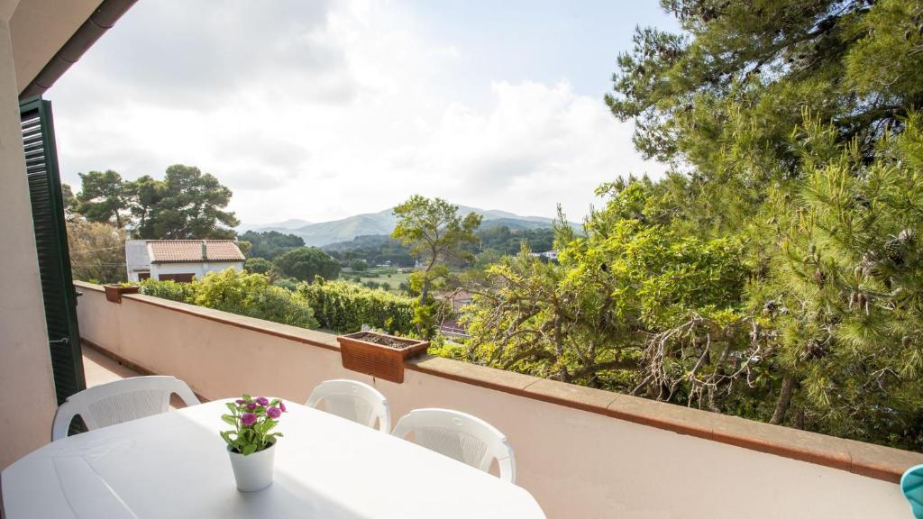 a balcony with a table and chairs and a view at Appartamenti Villa Anna - Goelba in Capoliveri
