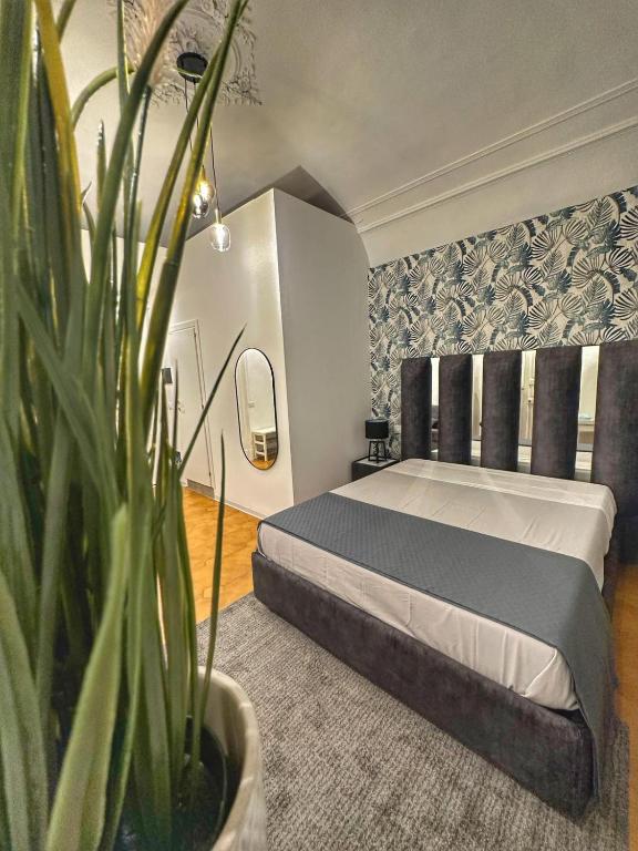 a bedroom with a bed and a potted plant at Boutique Rooms B&B in Catania