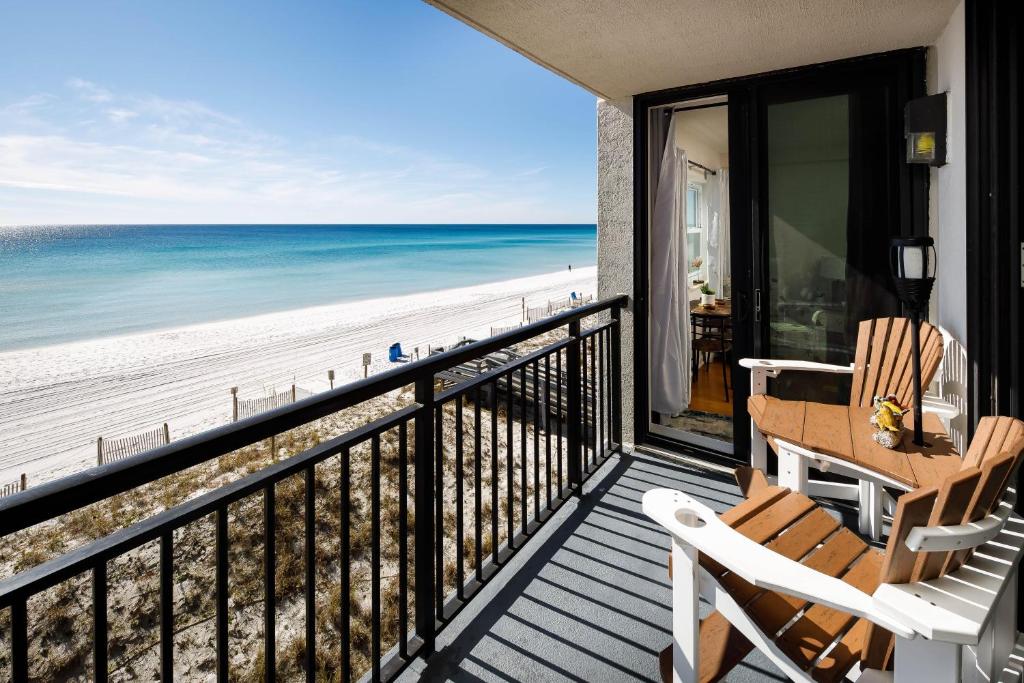 a balcony with two chairs and a view of the beach at Nautilus 1402 - Gulf Front 1 Bedroom - 4th Floor in Fort Walton Beach