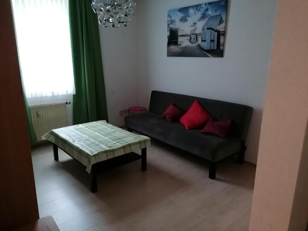 a living room with a couch and a table at Monteurwohnung App 5 in Pirmasens