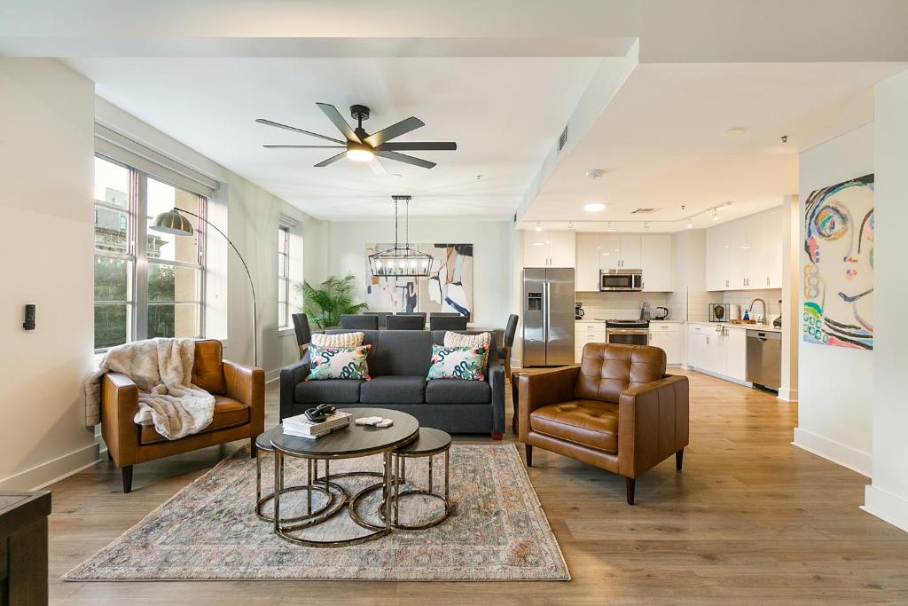 a living room with a couch and chairs and a table at Spacious 4-Bed Condo steps from French Quarter in New Orleans
