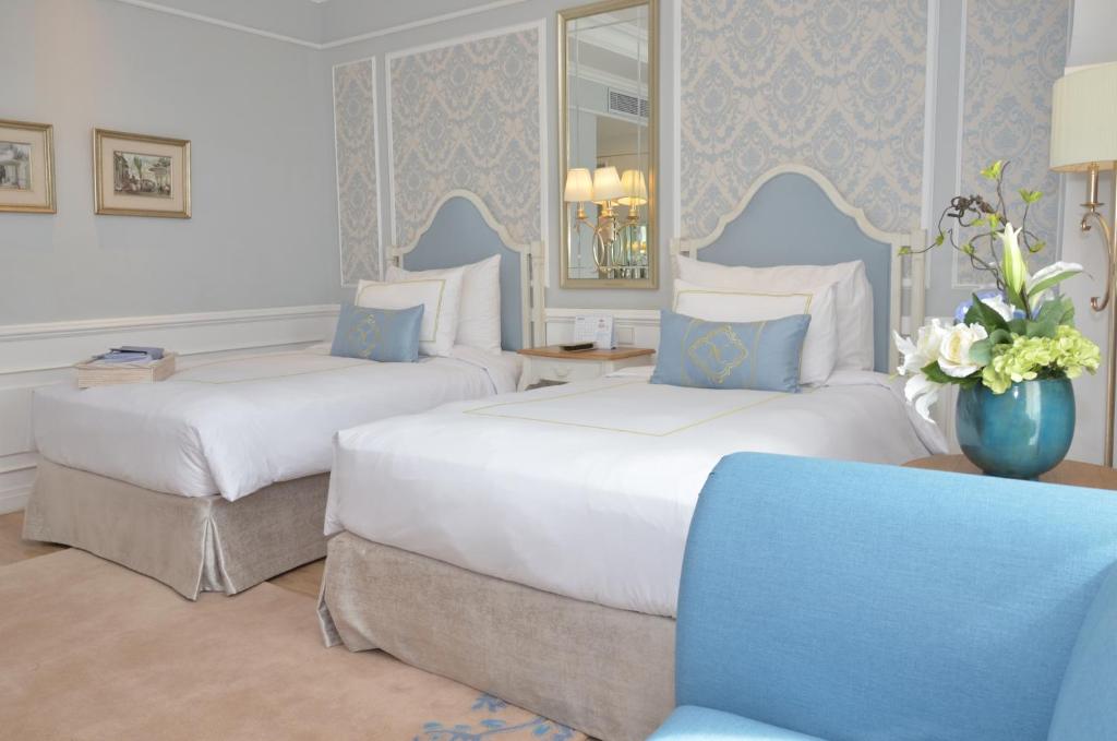 Postel nebo postele na pokoji v ubytování Noor Hotel