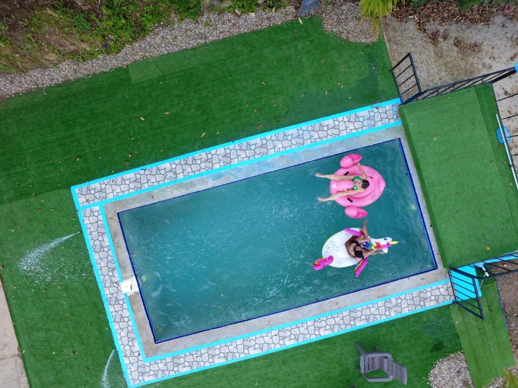 an overhead view of two people in a swimming pool at El piedron in Bogotá