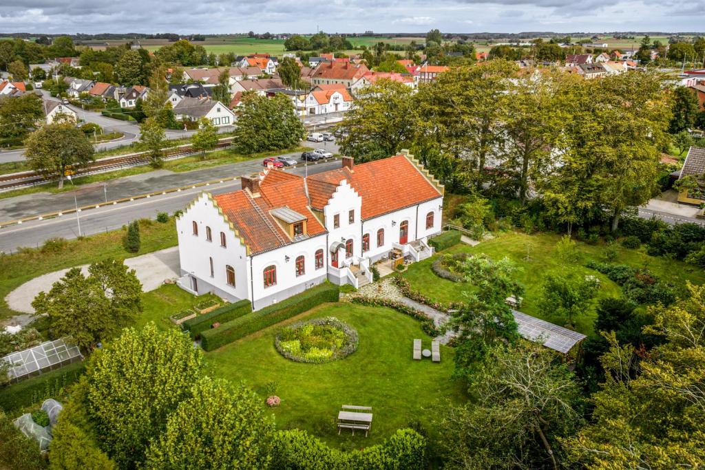 an aerial view of a large white house with a yard at Vita Huset på Österlen in Gärsnäs