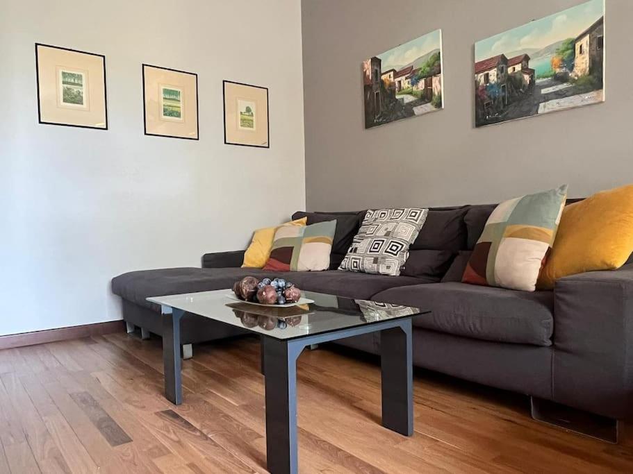 a living room with a couch and a table at Grace's House - Milan & Rho Fiera in Vittuone