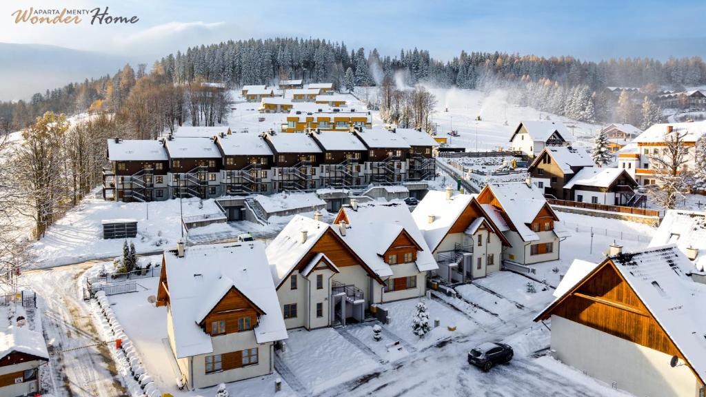 an aerial view of a village covered in snow at Wonder Home - Apartamenty Residence Karpacz blisko stoku narciarskiego, z balkonami i parkingiem in Karpacz