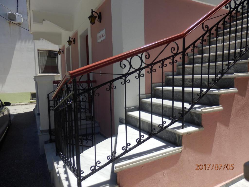 a staircase with a metal railing in a building at Dimi's studio in Skala Kallonis