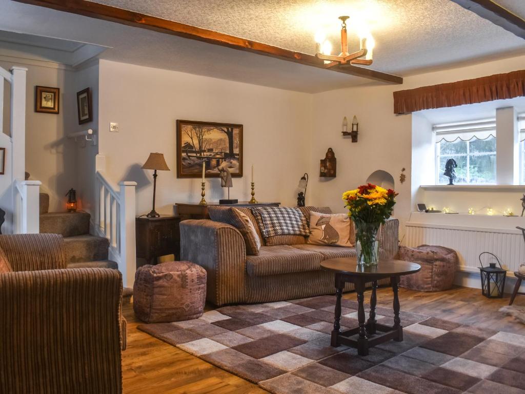 a living room with a couch and a table at The Greenwoods in Barrowford