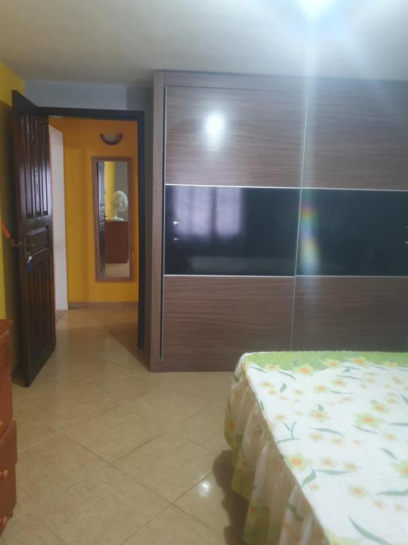 a bedroom with a sliding glass door with a bed at Casa temporada da Nenê in Ipitangas