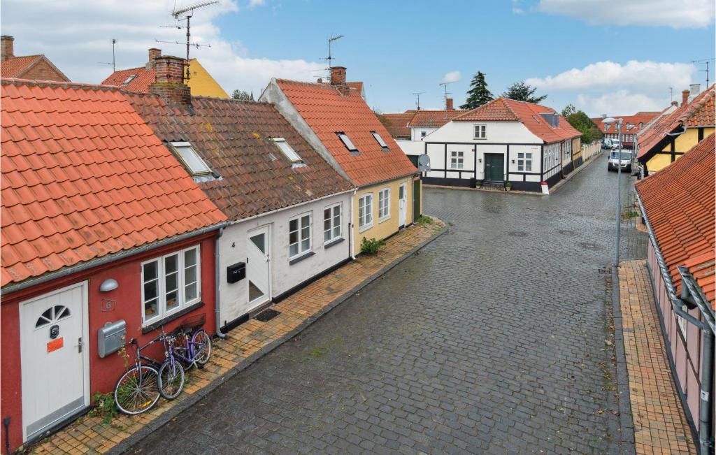 una calle en una ciudad con casas y bicicletas en Pet Friendly Home In Rnne With Kitchen, en Rønne