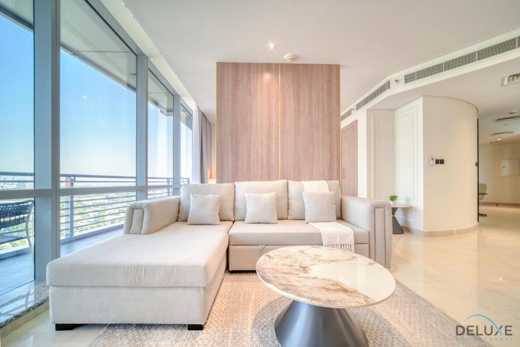 a living room with a white couch and a table at Spacious Studio at Sky Gardens DIFC by Deluxe Holiday Homes in Dubai