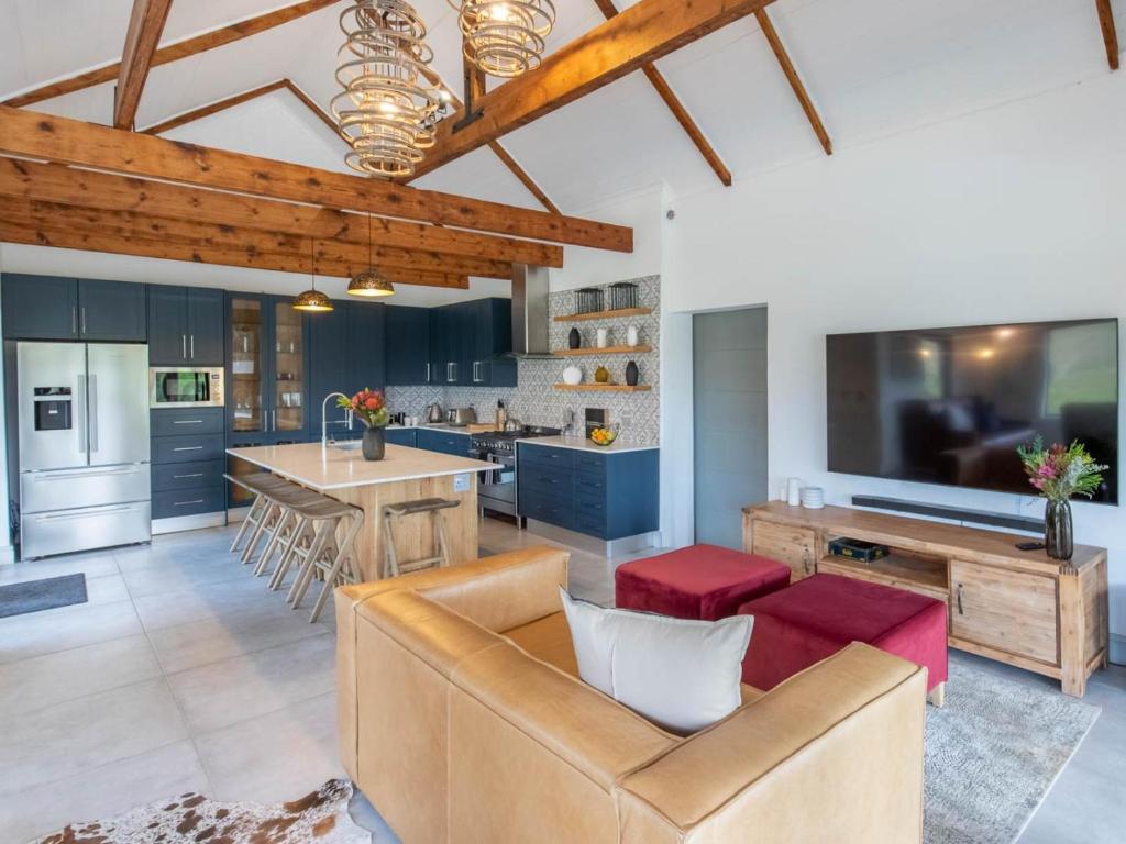 a kitchen and living room with a couch and a table at Ludicks Farm in Montagu