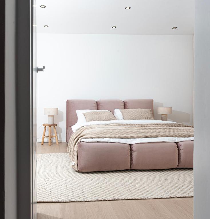a bedroom with a large bed and a large mirror at Apartament Węglowa 21 in Żywiec