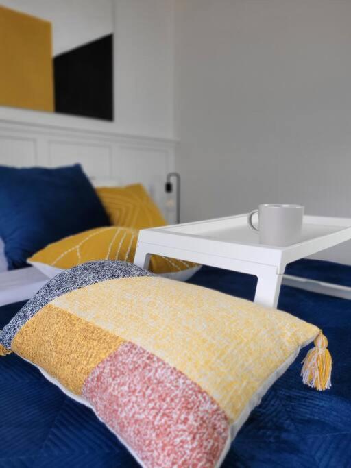 a pillow sitting on a couch with a table at Spot Caché - Private Waterfront Cottage in Papineauville