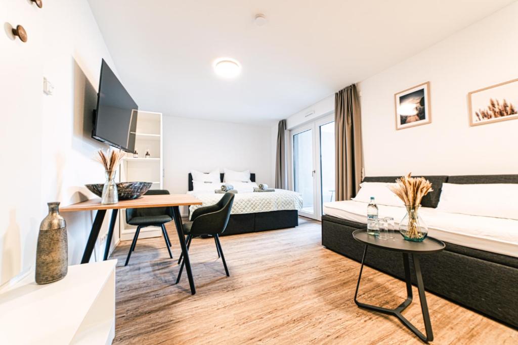 a hotel room with a bed and a desk at ZENtrahome - Zentral Outlet Business SmartTV Balkon in Metzingen